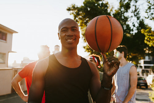 Basketball guys walking on street playing with the ball