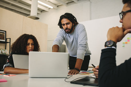Business colleagues discussing work in the board room
