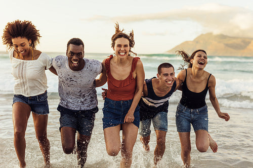Group of friends having fun at the beach