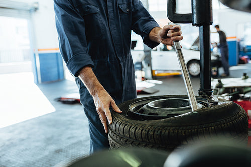 Mechanic working on tire changing machine