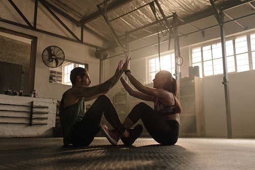 Couple exercising together at gym