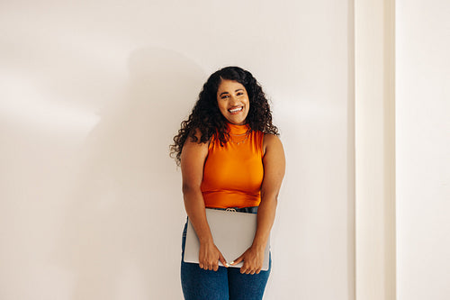 Young businesswoman smiling happily in a modern workplace