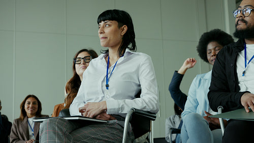 Businesswoman attentively listening during a business conference or educational seminar