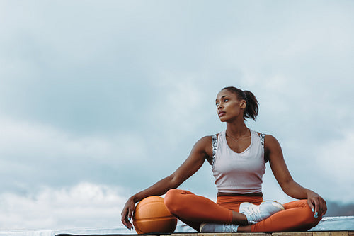 Fitness woman resting after workout on rooftop