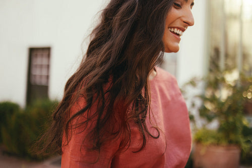 Young woman smiling outside a holiday resort