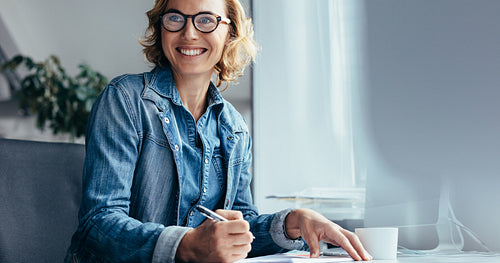 Caucasian woman working at her desk in office