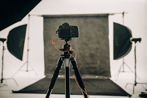 Digital camera mounted on a tripod in a photo studio