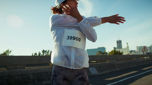 Female athlete stretching before an urban run