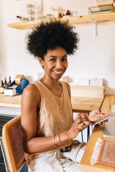 Jewelry business owner sitting in office desk