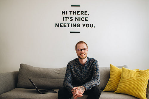 Successful businessman sitting on sofa at lobby 