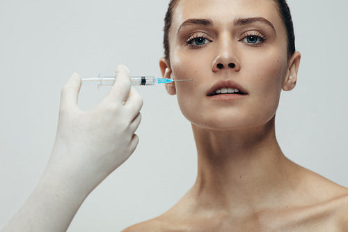 Beautiful woman gets injection in her face