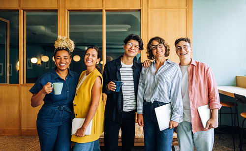 Group of cheerful colleagues enjoying time together in a shared office environment