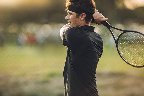 Pro tennis player practicing on a club court