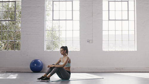 Woman doing abs crunches at fitness studio