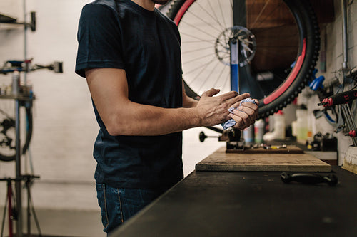 Mechanic repairing a bicycle in workshop