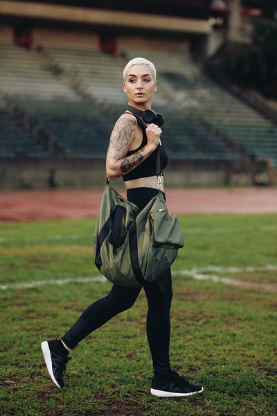 Fitness woman walking inside a track and field ground