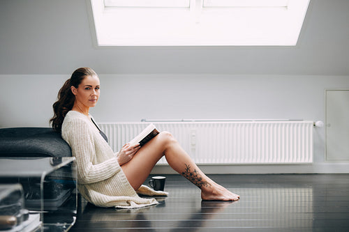 Beautiful woman reading a book at home