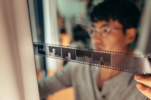 Photographer checking 35mm filmstrip 