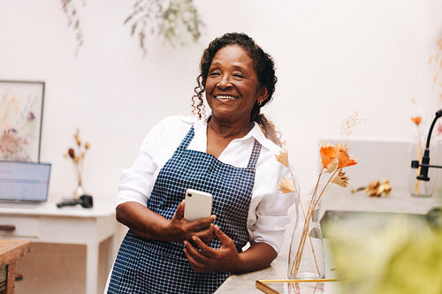 Happy senior woman running her own small business in the flower industry