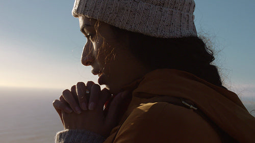 Woman in warm jacket and knitted cap outdoors