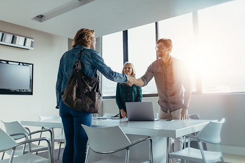 Business people shaking hands and finishing up meeting