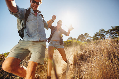 Happy young couple having fun on their hiking trip