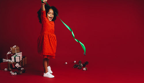 Kid having fun playing with a ribbon