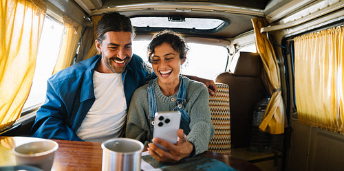 Couple in a van enjoying a sunny road trip