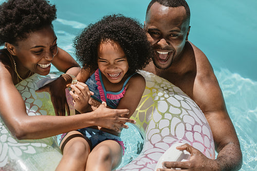 Family enjoying summer holidays in pool