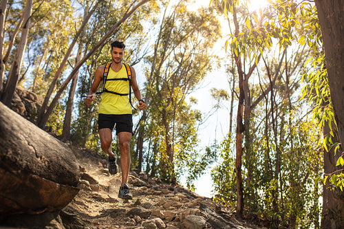 Man running over rocky trail on the hill