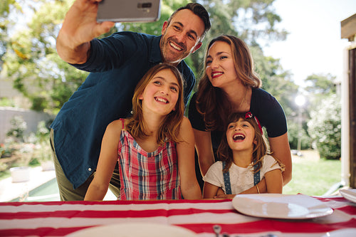 Man taking a selfie of his family