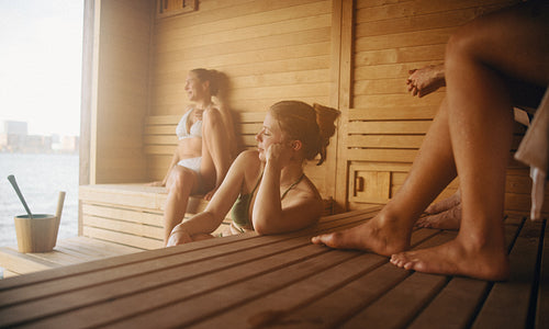 Women relaxing in a sauna session for wellness and recovery