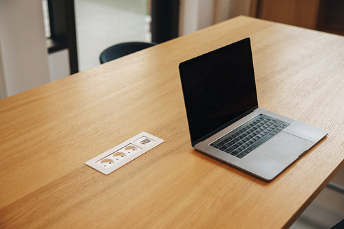 Laptop with blank screen in office conference room