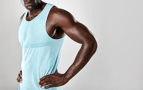 Muscular young african man standing with hands on hips
