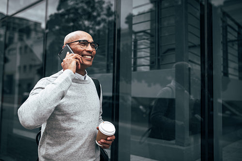 Entrepreneur using mobile phone while commuting to office