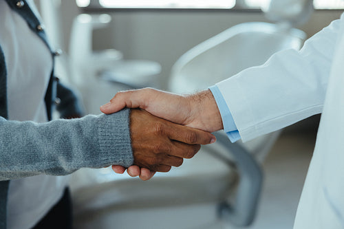 Close handshake signifies trust during healthcare consultation