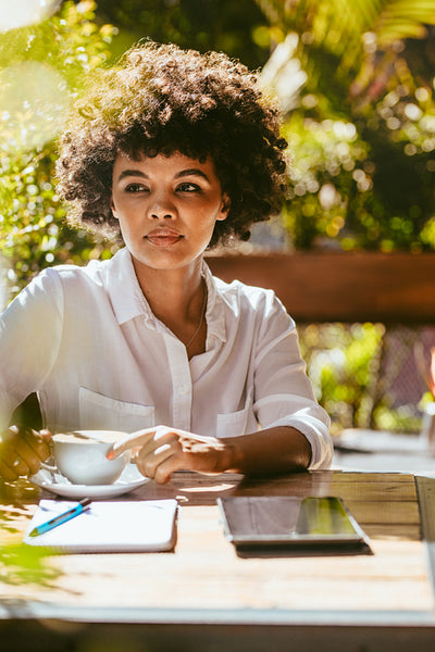 Woman relaxing at outdoor cafe
