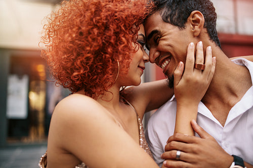 Young couple in a romantic mood out in the street.