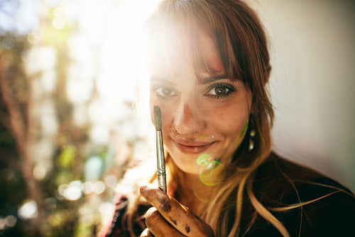 Face of female painter looking at camera