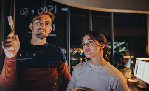 Collaborating after hours: Business team brainstorms ideas at night