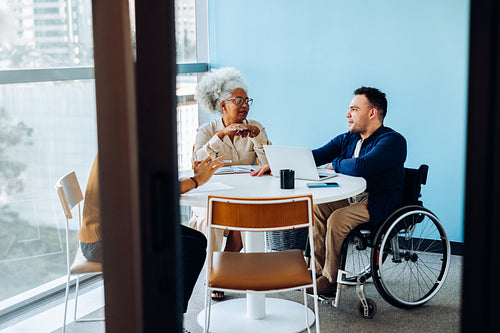 Meeting at round table with diverse team today