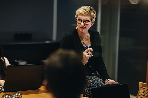 Corporate professional briefing team in boardroom