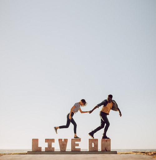 Friends walking over a word LIVE ON