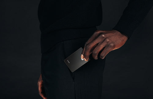 Professional and prestigious: Black business man pulling a premium credit card from his pocket