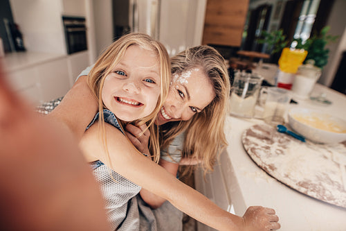 Happy family taking a selfie in kitchen