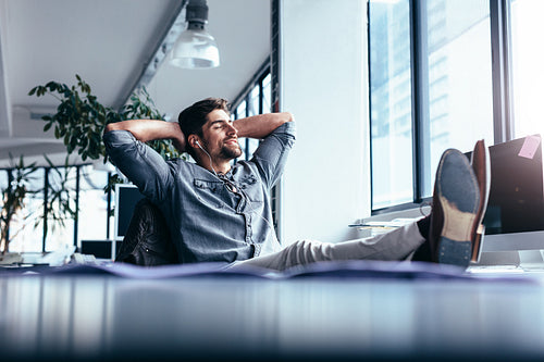 Male designer sitting relaxed at his workplace