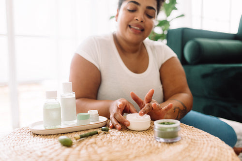 Woman using skin care cream