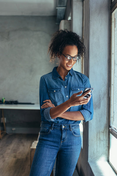 Businesswoman in office using a cell phone