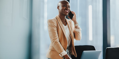 Happy, corporate business woman using a smartphone for communication in the office