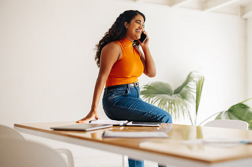 Successful businesswoman speaking on the phone in a boardroom